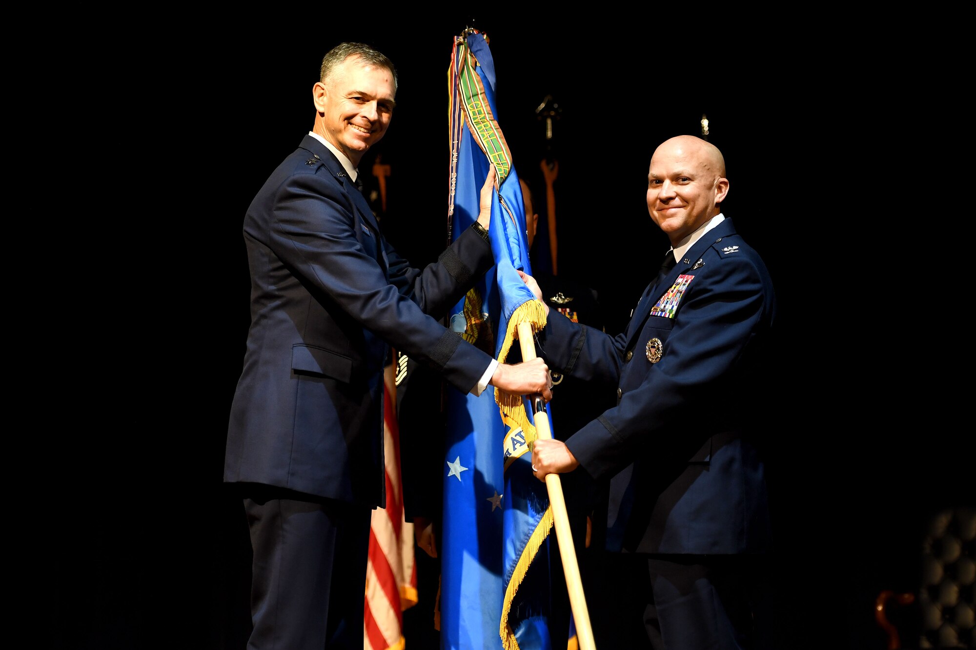 Col. Joseph Miller, incoming 314th Airlift Wing commander, right, assumes command of the 314th AW during a change of command ceremony June 16, 2020, at Little Rock Air Force Base, Arkansas. Miller, who began his Air Force career in 1998 after graduating the University of Alabama, is an evaluator/instructor in three variants of the C-130 and has accumulated over 2,800 flight hours including 590 combat hours in support of contingency operations. (U.S. Air Force photo Senior Airman Kristine M. Gruwell)