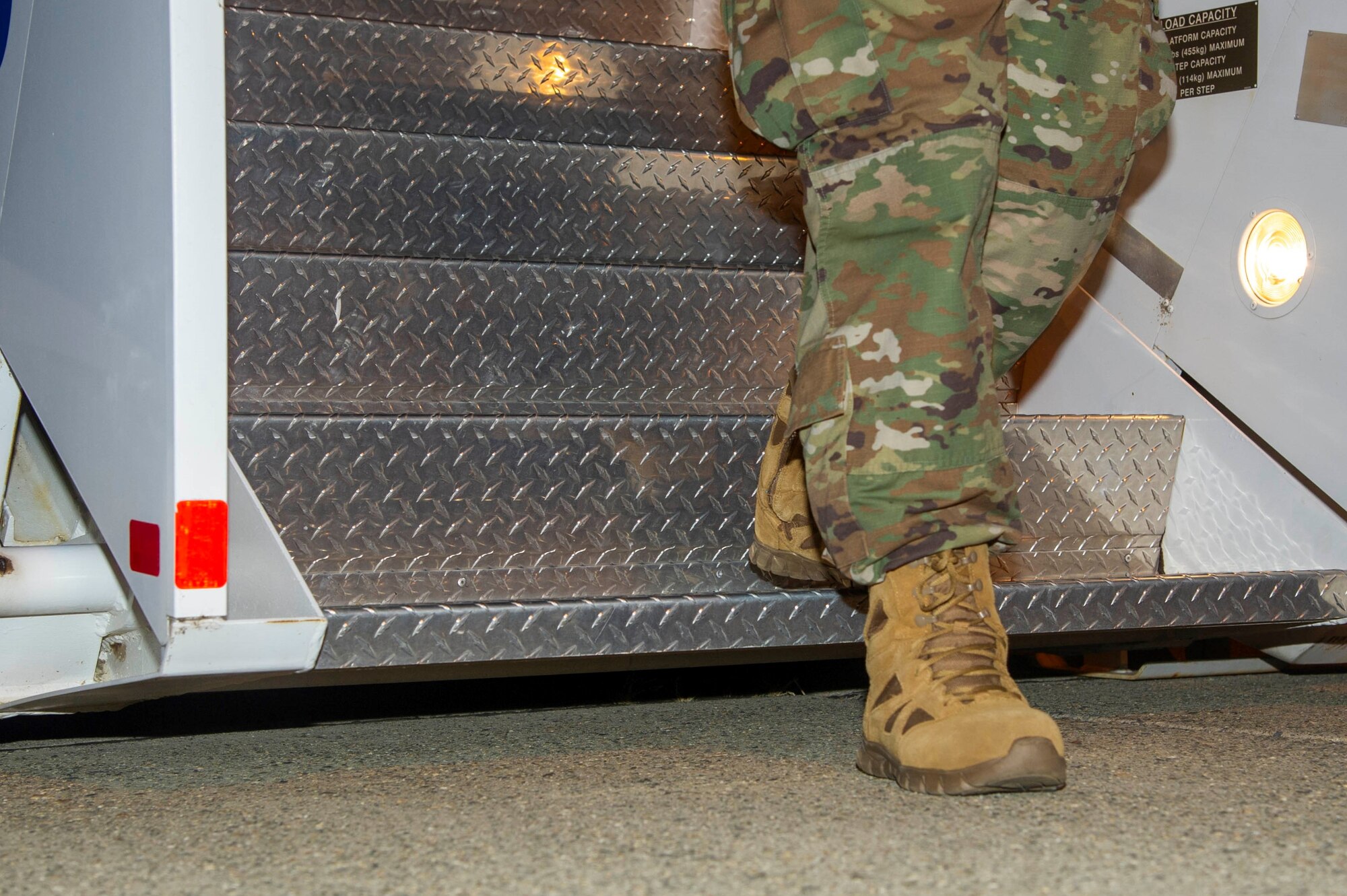 An Airman assigned to the 940th Maintenance Group deplanes and steps foot on to the ground after returning from deployment June 14, 2020, at Beale Air Force Base, California.