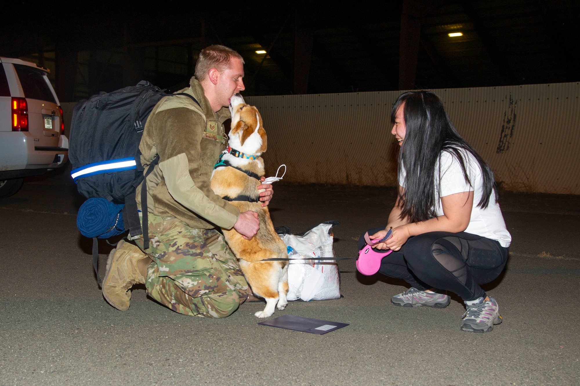 Tech. Sgt. David Diegel kneels with his wife, Mia Diegel, and hugs his dog, Cooper, June 14, 2020, at Beale Air Force Base, California.