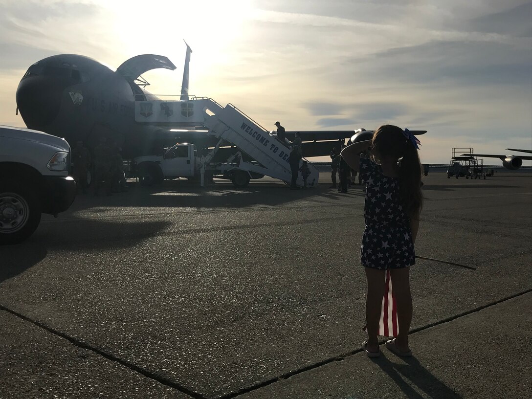 A young girl looks toward a KC-135 Stratotanker as she waits for her father June 14, 2020, at Beale Air Force Base, California.