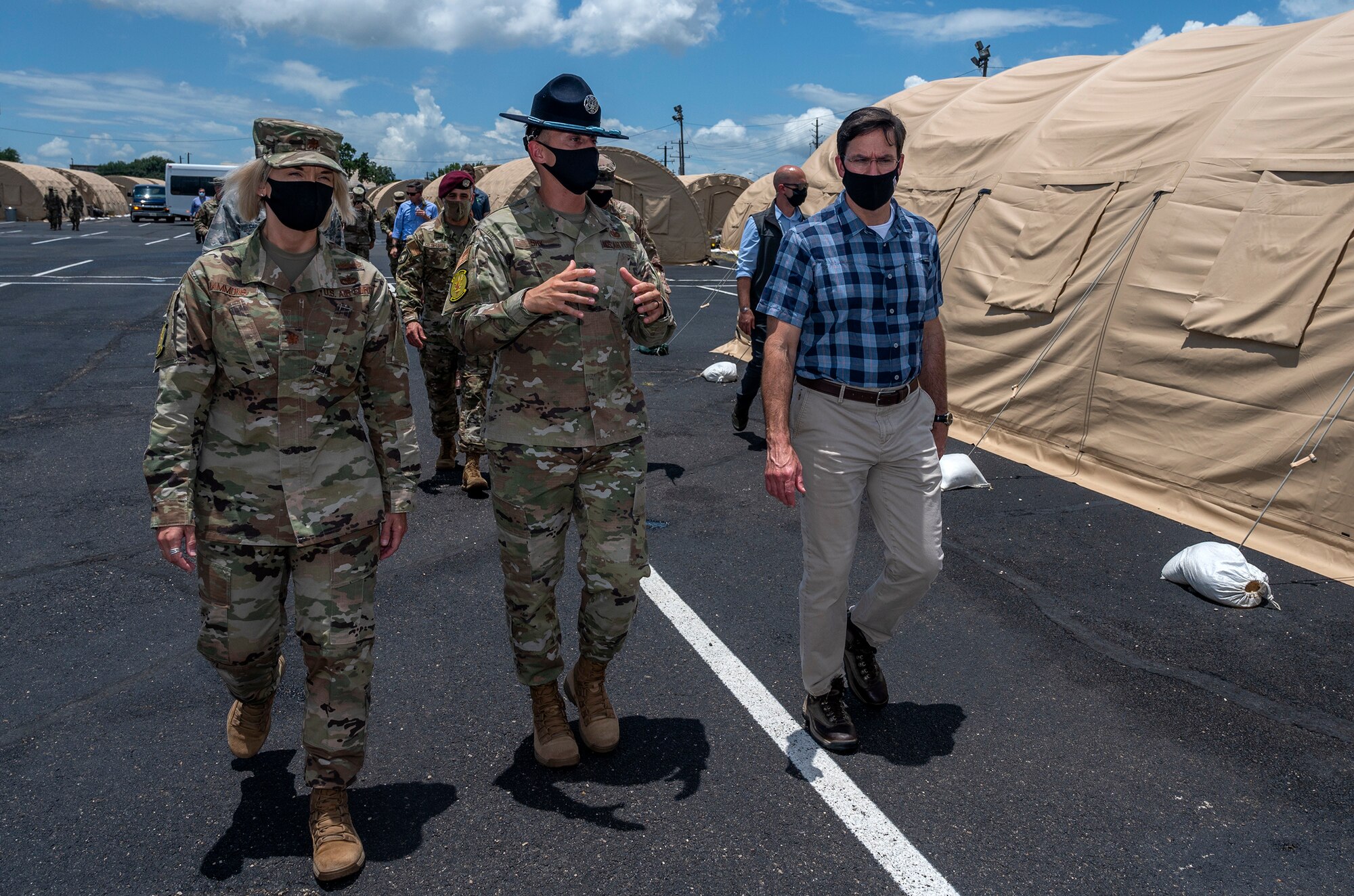 Tech. Sgt. Kyle Shy, 320th Training Squadron military training instructor, briefs U.S. Secretary of Defense Dr. Mark T. Esper during a tour of the U.S. Air Force basic military training's Basic Expeditionary Airfield Resources base June 16, 2020, at Joint Base San Antonio-Lackland, Texas. Esper met with AETC leaders to see firsthand how BMT is fighting through COVID-19 with health protection measures in place and adapting operations to current Centers for Disease Control and Prevention Guidance. The visit also allowed him to witness how a citizen becomes an Airman during COVID-19.