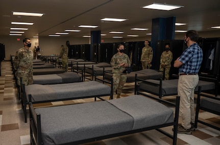 Tech. Sgt. Sarah Mitchell, 323rd Training Squadron military training instructor, briefs U.S. Secretary of Defense Dr. Mark T. Esper during his tour of the 323rd Training Squadron's Airman Training Complex June 16, 2020, at Joint Base San Antonio-Lackland, Texas. Esper met with AETC leaders to see firsthand how Basic Military Training is fighting through COVID-19 with health protection measures in place and adapting operations to current Centers for Disease Control and Prevention Guidance. The visit also allowed him to witness how a citizen becomes an Airman during COVID-19.