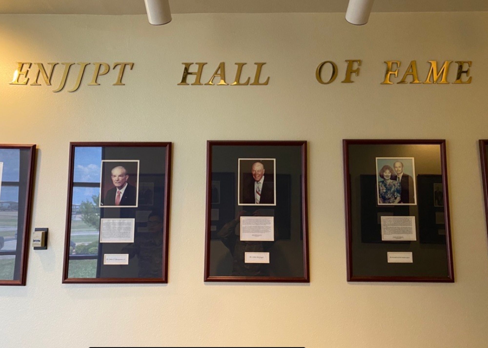 Photos of Euro-NATO Joint Jet Pilot Training Program's Hall of Fame members are displayed at Sheppard Air Force Base, June 15, 2020. The ENJJPT Hall of Fame was established in 1993 to honor the men and women in the local community for their outstanding support to the multi-national program. Glen Barham, President of the Sheppard Military Affairs Committee, and his wife, Mary Lynne, are the 17th and most recent inductees to receive this prestigious accomplishment. (U.S. Air Force photo by 2nd Lt. Megan Morrissey)