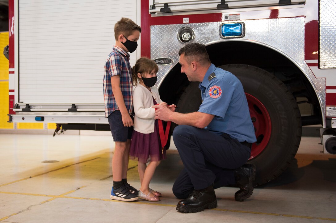 Lee Joyce, 423rd Civil Engineer Squadron lead firefighter, is awarded the Fire Department’s Life Saving Medal at RAF Alconbury, England, June 16, 2020, for saving his daughter’s life. Lee utilized his firefighter training to assist his four-year-old daughter when she was chocking on a chocolate egg May 16, 2020. (U.S. Air Force photo by Airman 1st Class Jennifer Zima)