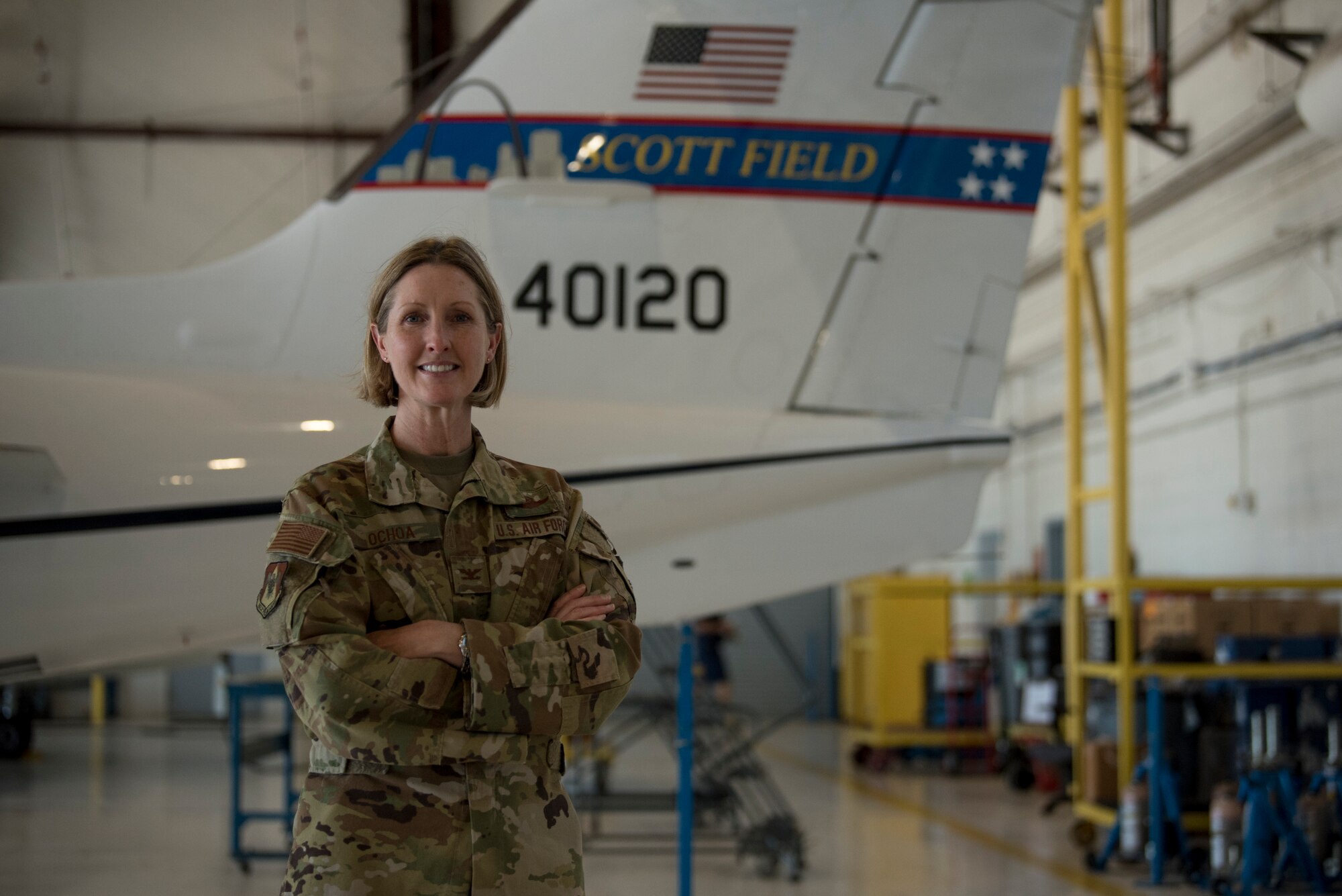 U.S. Air Force officer stands in front of aircraft