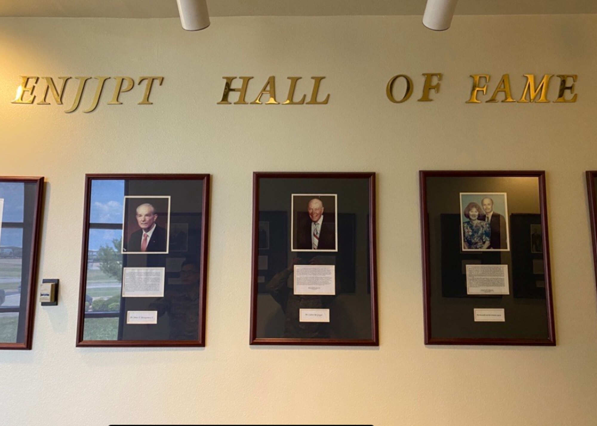 Photos of Euro-NATO Joint Jet Pilot Training Program's Hall of Fame members are displayed at Sheppard Air Force Base, June 15, 2020. The ENJJPT Hall of Fame was established in 1993 to honor the men and women in the local community for their outstanding support to the multi-national program. Glen Barham, President of the Sheppard Military Affairs Committee, and his wife, Mary Lynne, are the 17th and most recent inductees to receive this prestigious accomplishment. (U.S. Air Force photo by 2nd Lt. Megan Morrissey)