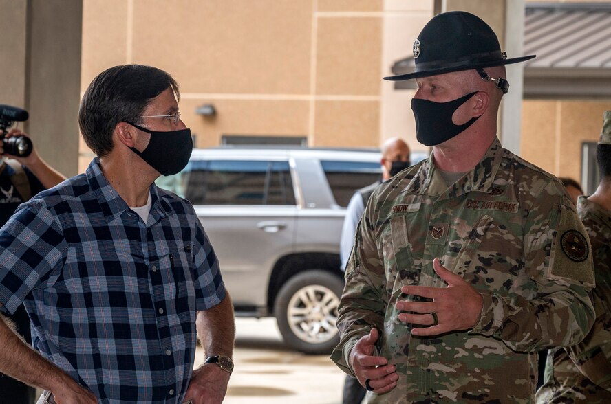 Tech. Sgt. Kenneth Snow, 323rd Training Squadron military training instructor, briefs U.S. Secretary of Defense Dr. Mark T. Esper during his tour of the 323rd Training Squadron's Airman Training Complex June 16, 2020, at Joint Base San Antonio-Lackland, Texas. Esper met with AETC leaders to see firsthand how Basic Military Training is fighting through COVID-19 with health protection measures in place and adapting operations to current Centers for Disease Control and Prevention Guidance. The visit also allowed him to witness how a citizen becomes an Airman during COVID-19.