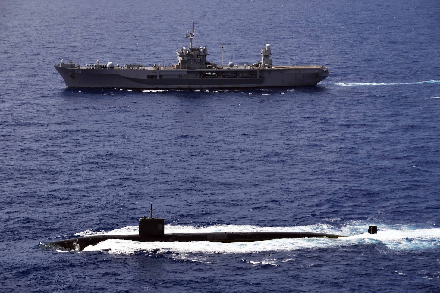 PHILLIPPINE SEA (June 14, 2020) Los Angeles-class fast-attack submarine, USS Asheville (SSN 758), transits alongside U.S. 7th Fleet flagship USS Blue Ridge (LCC 19) during a submarine familiarization (SUBFAM). The SUBFAM was conducted so Blue Ridge's crew and embarked 7th Fleet staff could observe the characteristics of a submarine and how it looks both digitally and visually at periscope depth. Blue Ridge is the oldest operational ship in the Navy, and, as 7th Fleet flagship, actively works to foster relationships with allies and partners in the Indo-Pacific region.