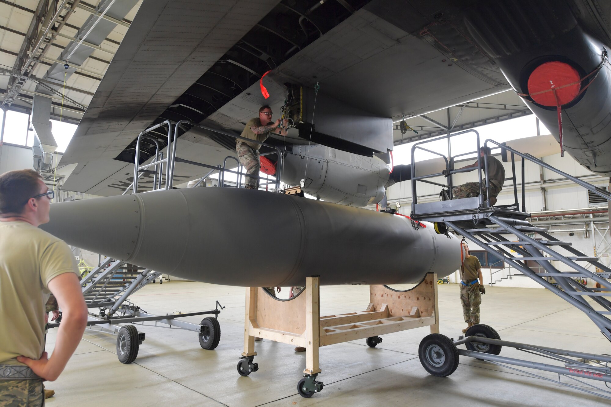 A photo of Airmen working on an aircraft.
