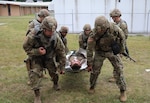 New York Army National Guard Soldiers assigned to the 466th Medical Company, Area Support, lift a simulated patient during a mass casualty exercise at pre-mobilization training at Camp Smith Training Site in Cortlandt Manor, N.Y. The company is deploying to the area of Central Command this summer.