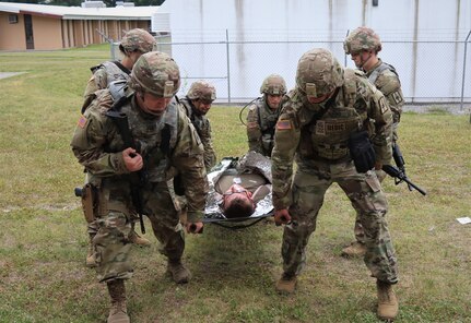 New York Army National Guard Soldiers assigned to the 466th Medical Company, Area Support, lift a simulated patient during a mass casualty exercise at pre-mobilization training at Camp Smith Training Site in Cortlandt Manor, N.Y. The company is deploying to the area of Central Command this summer.