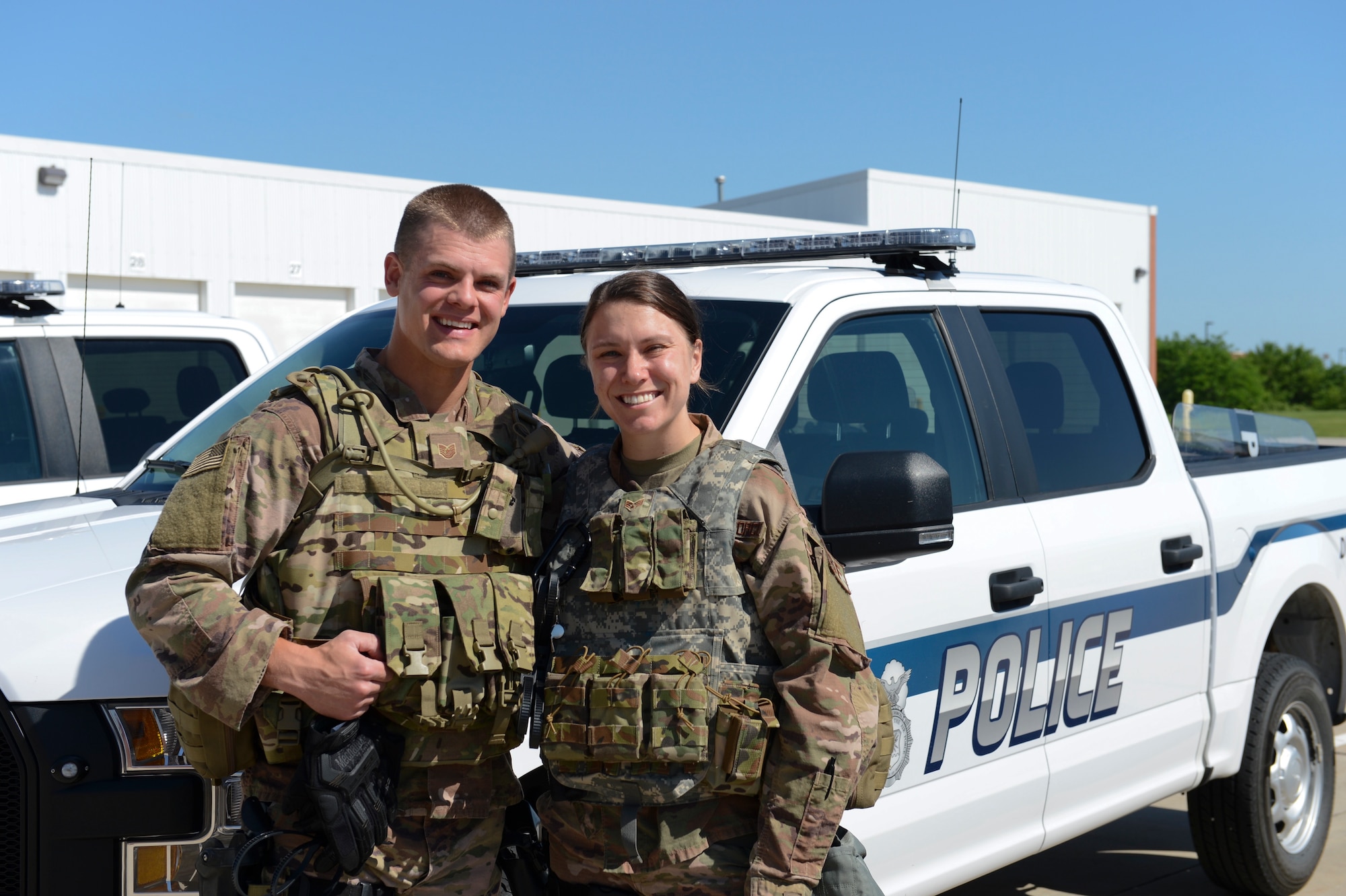 Nebraska National Guard Tech Sgt. Kenny Morrison and his wife Senior Airman Grace Morrison, both military police officers with the 155th Security Forces Squadron, pose together for a photo in front of a Nebraska Air National Guard police truck, June 4, 2020, at the Nebraska National Guard air base in Lincoln, Nebraska. The Morrisons were both called to duty to embed with the Lincoln Police Department and other civil authorities after the Nebraska National Guard was activated to help ensure the safety of Nebraskans participating lawfully in peaceful demonstrations and to protect property, including the Lancaster County Court Hall of Justice. The dual Citizen-Airmen couple celebrated their second wedding anniversary while on duty supporting this domestic response mission. (Nebraska National Guard photo by Tech. Sgt. R. Denise Mommens)