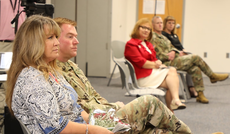 U.S. Army Corps of Engineers Transatlantic Division Commander Col. Christopher Beck and his wife Sally listen as USACE Commanding General Lt. Gen. Todd T. Semonite delivers remarks during Beck’s relinquishment of command ceremony held June 16, 2020, in Winchester, Virginia. Semonite hosted the event, which was modified to incorporate social distancing due to COVID-19, meaning couples could sit together but everyone else had to maintain at least six feet of distance. Picture in the background are Connie Semonite, and USACE Command Sergeant Major Bradley Houston and his wife, Kim.