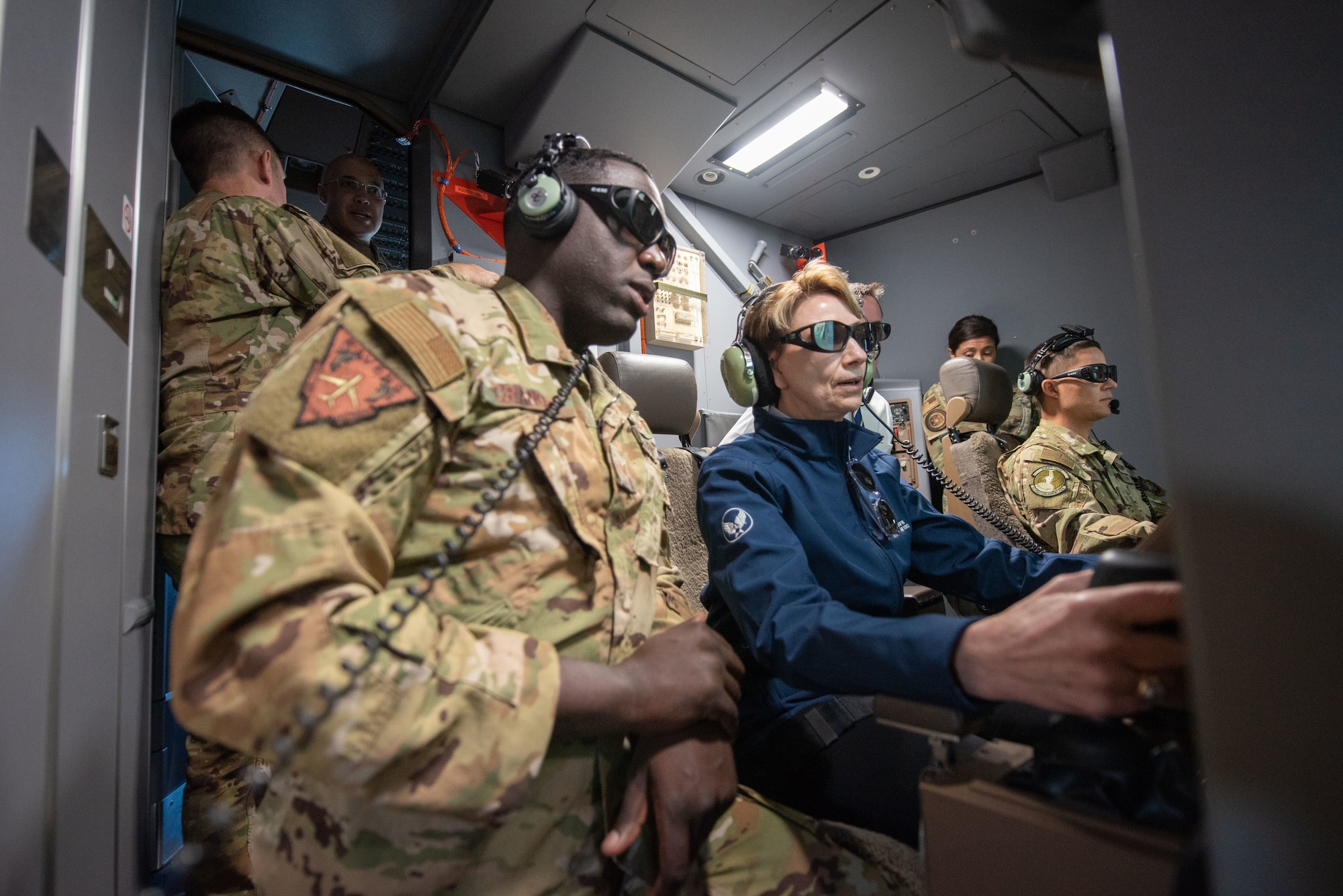 Staff Sgt. Devaughn Granger, 344th Air Refueling Squadron in-flight refueling specialist evaluator, left, shows Secretary of the Air Force Barbara Barrett the functionality of the KC-46A Pegasus boom June 10, 2020, above Kansas. Barrett flew on a day-to-night flight to witness the aircraft’s remote vision system’s capability in various lighting conditions. (U.S. Air Force photo by Staff Sgt. Chris Thornbury)