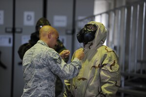 Staff Sgt. Omar M. Mincey, 940th Air Refueling Wing emergency manager, inspects the chemical, biological, radiological and nuclear uniform of Staff Sgt. Gilbert Brooks, 940th Logistics Readiness Squadron decentralized material supply technician, June 13, 2020, at Beale Air Force Base, California.