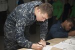 A Sailor registers for the 2012 presidential election and submits an absentee ballot request to the command’s voting representative aboard the aircraft carrier USS John C. Stennis while at sea in the Pacific Ocean, Sept. 4, 2012.
