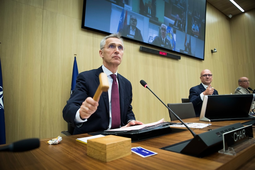 A man raps a gavel on a table.