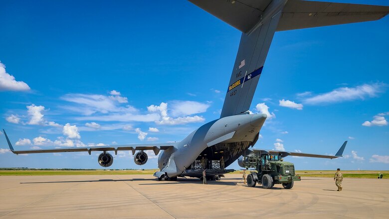 82nd LRS Airmen unload hand sanitizer from a C-17