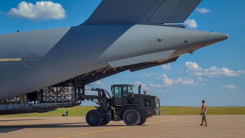 82nd LRS Airmen unload hand sanitizer from a C-17