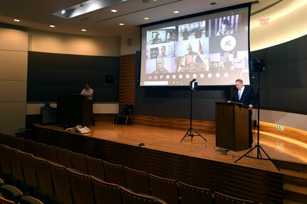 Finalists and panel judges are projected on a screen during the first National Guard Innovation Competition as Charles Crosby, right, a senior analyst with the National Guard Bureau’s Force, Structure and Assessment Directorate, serves as the emcee for the event at the Herbert R. Temple Jr. Army National Guard Readiness Center, Arlington Hall Station, June 12, 2020. A Texas National Guard innovation team won the competition’s top honor for helping develop advanced 3D printer technology.