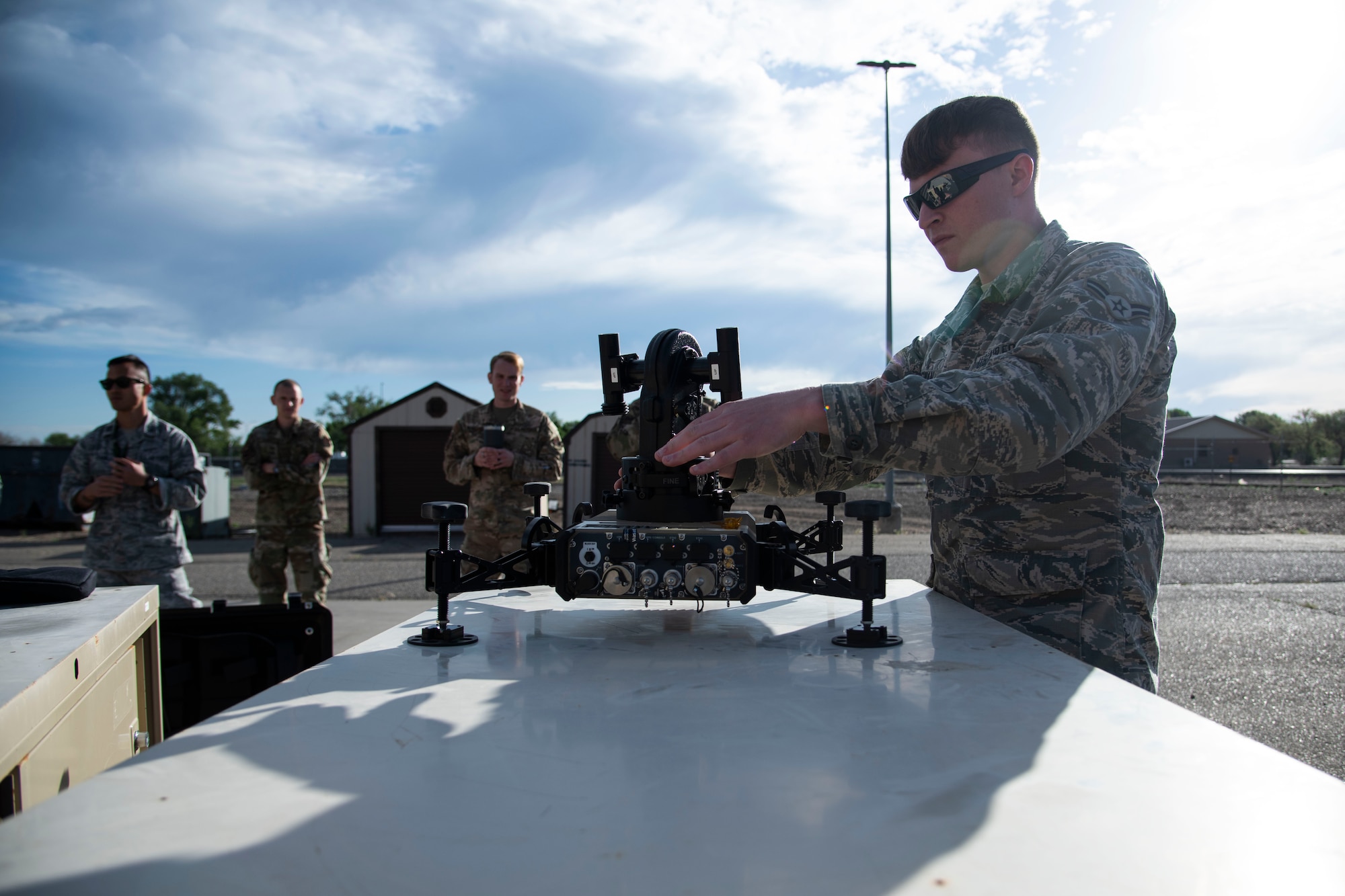 U.S. Air Force Airman 1st Class Nicholas McCowan, 366th Fighter Wing A2 (Intell) Joint Worldwide Intelligence Communication System Intelligence System Security Manager, demonstrates assembly of the multi-mission toolset, or MMT, June 3, 2020, at Mountain Home Air Force Base, Idaho,. The portable satellite dish McCowan is assembling allows for communication across long distances in remote locations. (U.S. Air Force photo by Airman 1st Class Nicholas Swift)