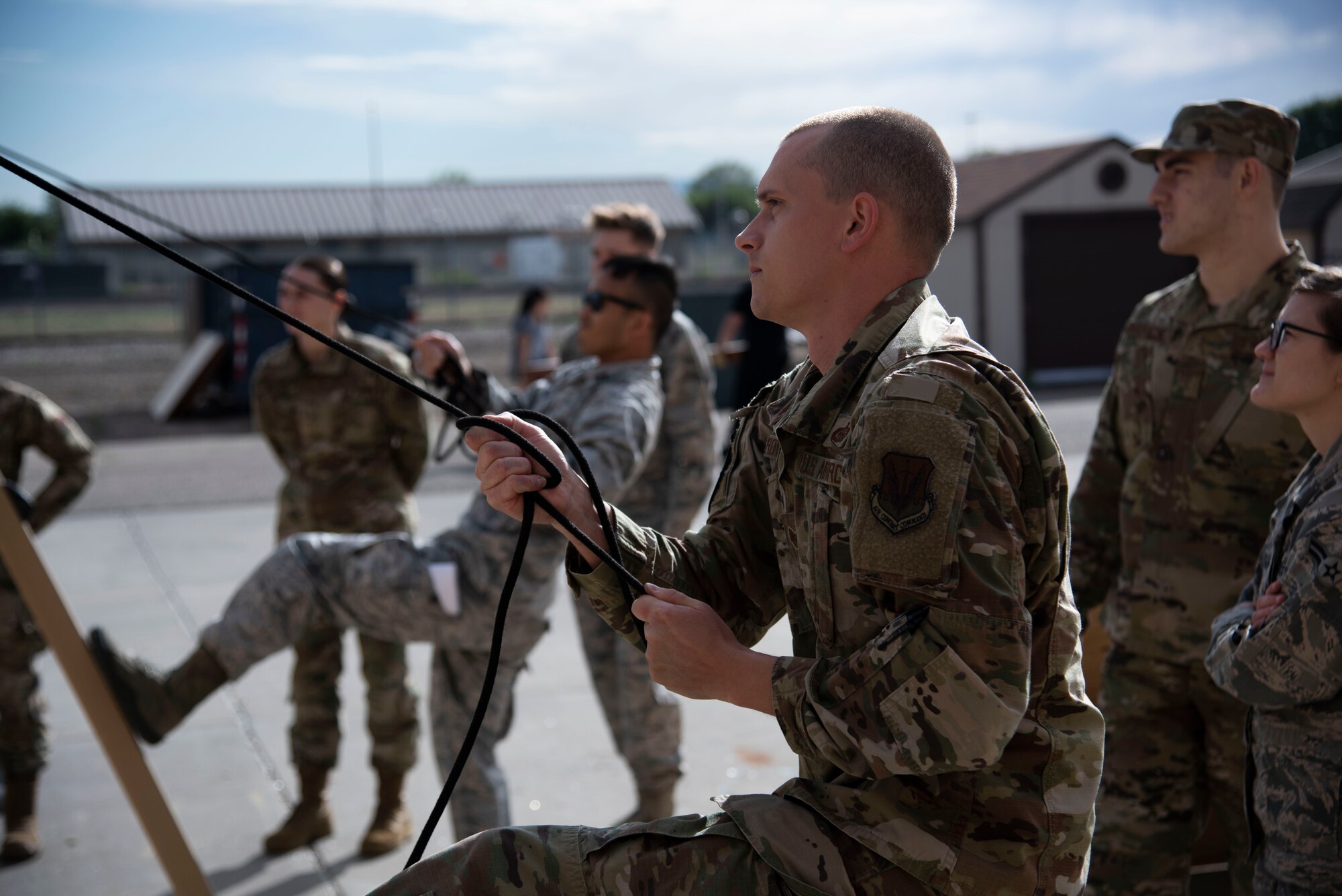 U.S. Air Force Staff Sgt. Jacob Royse, 366th Fighter Wing A2 (Intell) NCOIC of combat intell cell (front), and U.S. Air Force Capt. Menji Chiem, 366th Fighter Wing A2 chief of weapons (back), tighten the ropes of a TM18 tent on Mountain Home Air Force Base, Idaho, June 3, 2020. The TM18 tent is designed for both quick assembly and durability in extreme conditions making it ideal for Agile Combat Employment. (U.S. Air Force Photo by Airman 1st Class Nicholas Swift)