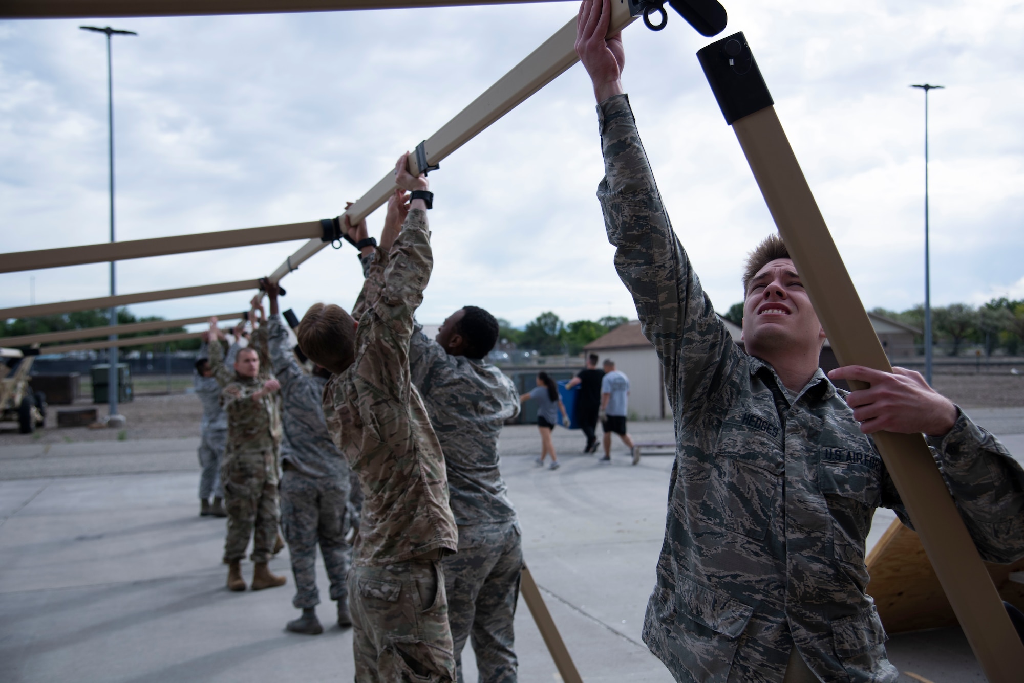 366th Fighter Wing A2 (Intell) Airmen attach the legs of the support structure to the TM60 tent, June 3, 2020, on Mountain Home Air Force Base, Idaho. A trained team of Airmen are able to fully assemble the TM60 tent and have it mission ready in 30 minutes. (U.S. Air Force photo by Airman 1st Class Nicholas Swift)