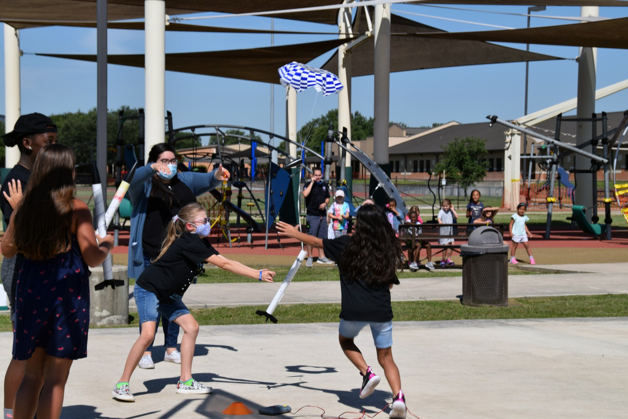 Violet Schwerdtfeger and Malia Norman, STARBASE Kelly summer camp students, attempt to catch a descending rocket as Valerie Acosta, STARBASE Kelly, summer camp instructor, directs them towards the rocket’s descent June 12, 2020 at the Lackland Youth Center, Joint Base San Antonio-Lackland, Texas.