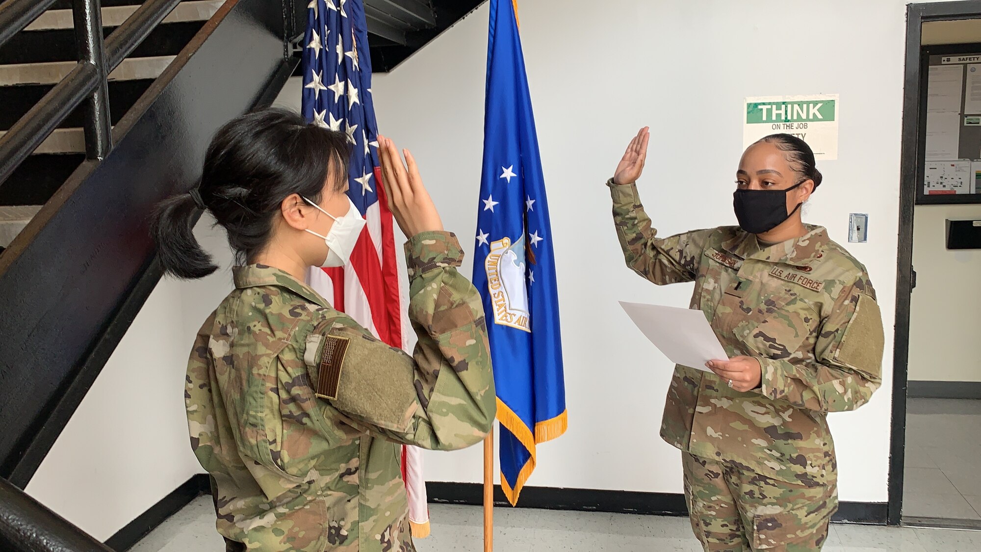 1st Lt. Shakia Johnson, 69th Aerial Port Squadron, swears Staff Sgt. Dana Lee, 69th APS, air transportation technician, into active duty June 15, 2020, at Joint Base Andrews. Md. Lee is one of eight Airmen selected Air Force-wide for the Enlisted to Medical Degree Preparatory Program. (Courtesy photo)
