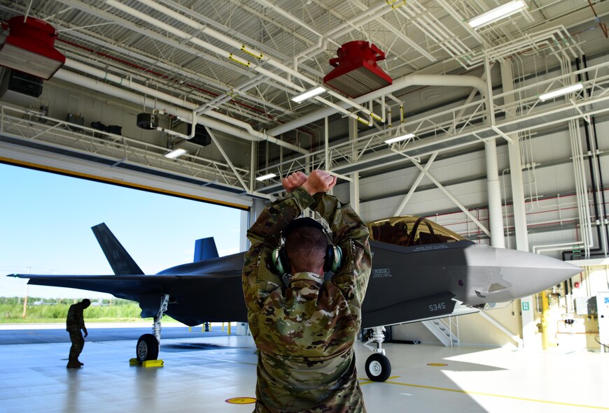 U.S. Air Force Airman 1st Class Anthony Clark, a 356th Aircraft Maintenance Unit F-35A Lightning II crew chief, prepares to launch an F-35A at Eielson Air Force Base, Alaska, June 17, 2020.