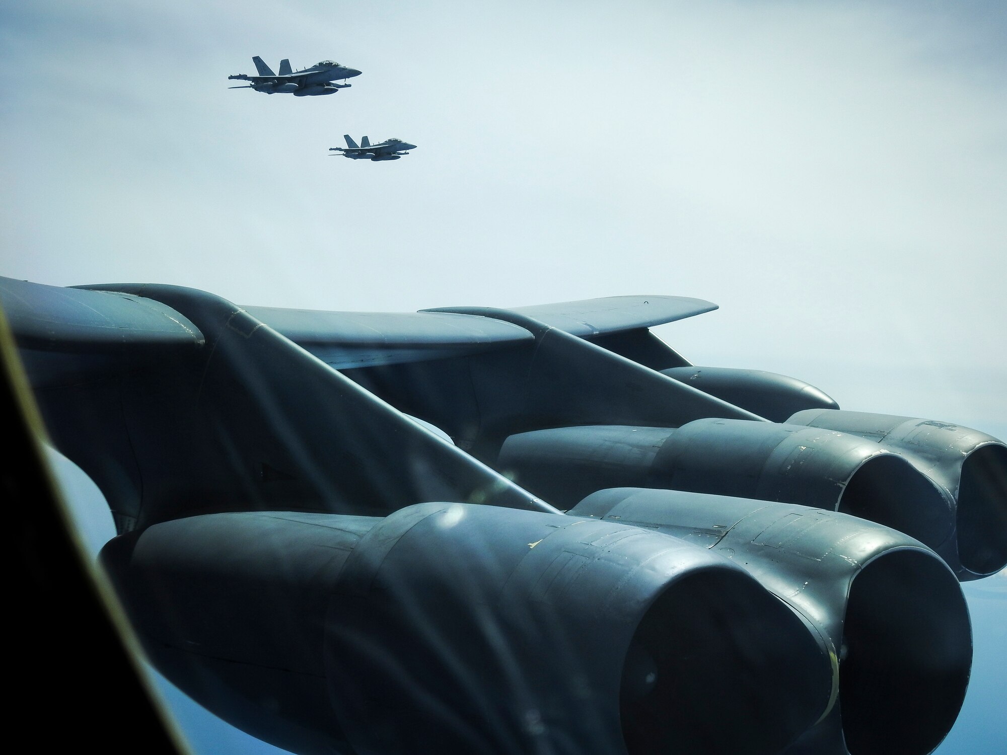 Two United States Navy E/A-18G Growlers from Electronic Attack Squadron 209, the “Star Warriors,” fly with a B-52H Stratofortress deployed from Barksdale Air Force Base, La., over the Sea of Japan while conducting a Bomber Task Force mission June 16, 2020. Strategic bomber missions contribute to joint force lethality, assure allies and partners, and deter aggression in the Indo-Pacific. (Courtesy photo)