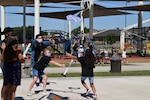Violet Schwerdtfeger and Malia Norman, STARBASE Kelly summer camp students, attempt to catch a descending rocket as Valerie Acosta, STARBASE Kelly, summer camp instructor, directs them towards the rocket’s descent June 12, 2020 at the Lackland Youth Center, Joint Base San Antonio-Lackland, Texas.
