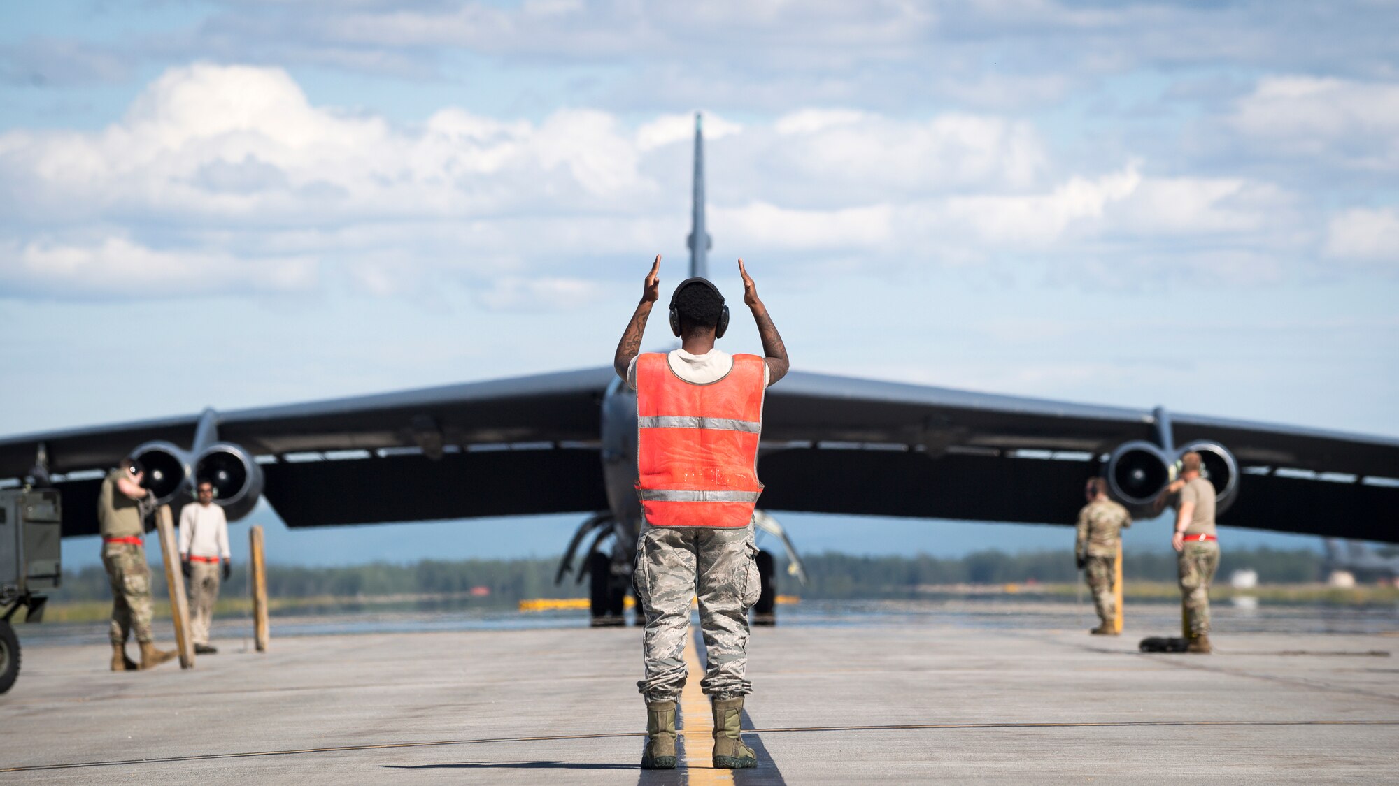 Senior Airman Jar’quayla Doss, 96th Aircraft Maintenance Unit electronic countermeasures journeyman, marshalls a B-52H Stratofortress deployed from Barksdale Air Force Base, La., at Eielson Air Force Base, Alaska,  June 17, 2020. Bomber Task Force missions provide a persistent bomber presence in the Indo-Pacific theater and around the globe. (U.S. Air Force photo by Senior Airman Lillian Miller)