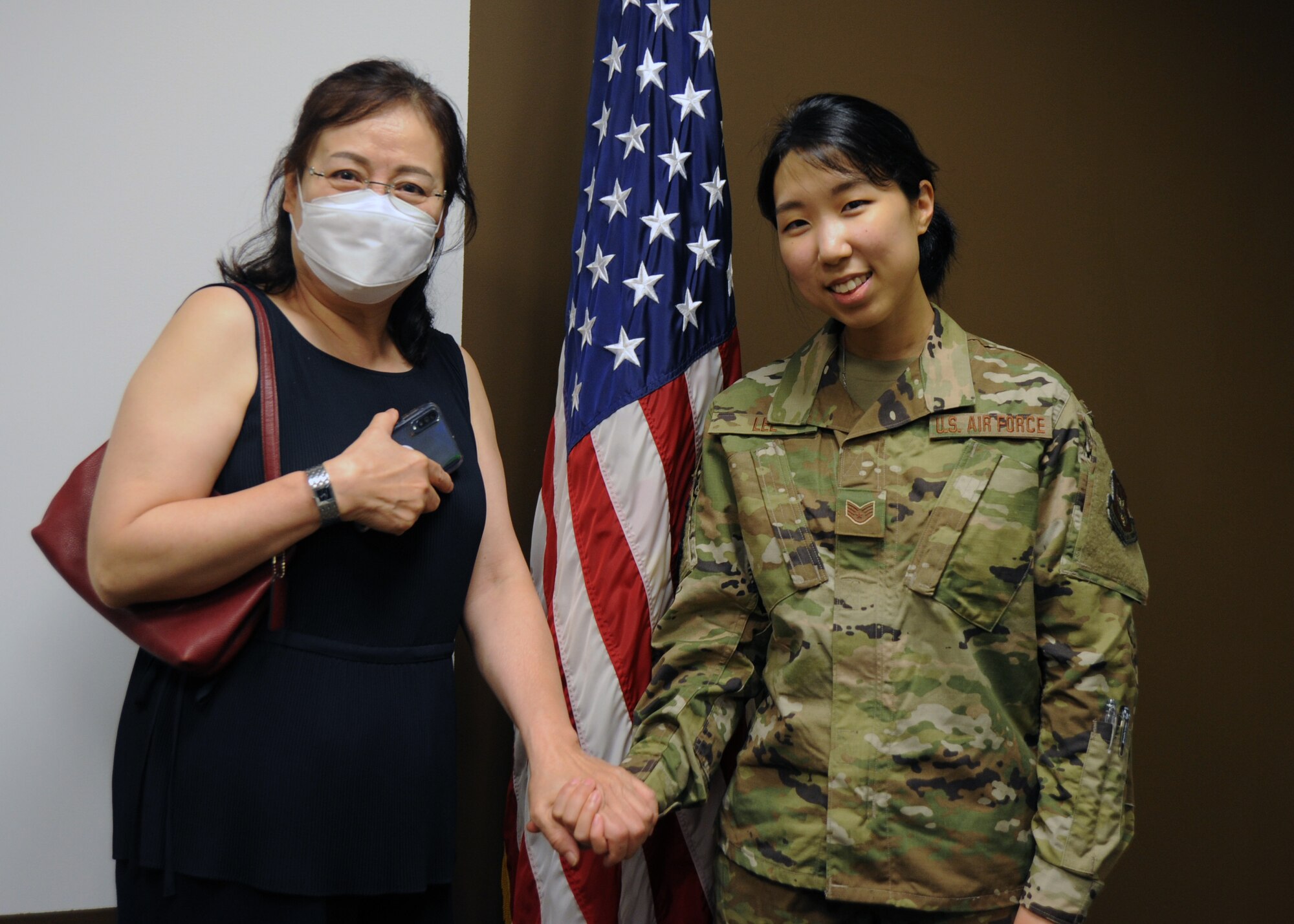 Staff Sgt. Dana Lee, 69th Aerial Port Squadron, air transportation technician, poses for a photo with her mother, Chanel Lee, after being sworn into active duty June 15, 2020, at Joint Base Andrews, Md. Lee is one of eight Airmen selected Air Force-wide for the Enlisted to Medical Degree Preparatory Program. (U.S. Air Force photo by Staff Sgt. Cierra Presentado)