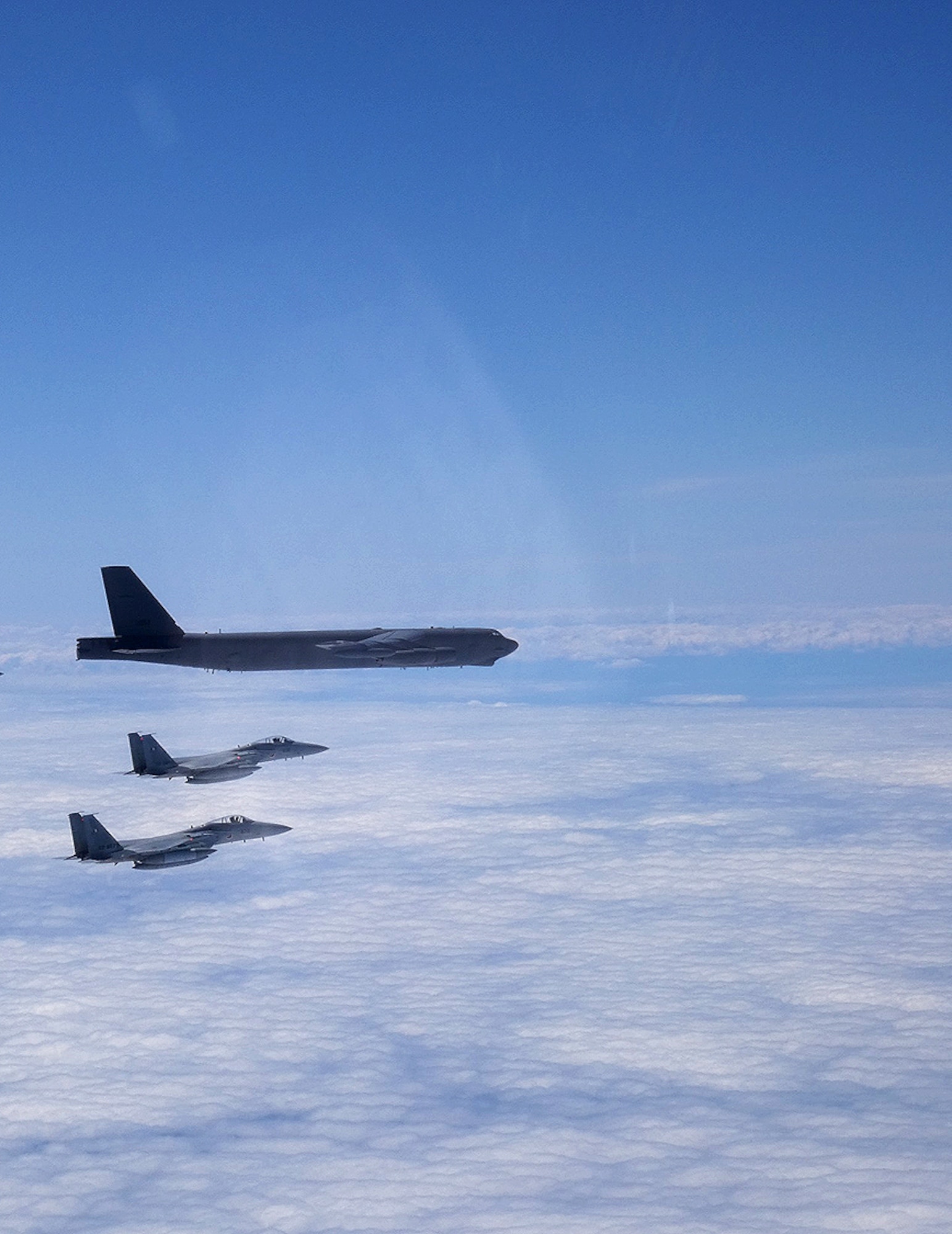 A B-52H Stratofortress deployed from Barksdale Air Force Base, La., flies alongside two Japan Air Self-Defense Force F-15s over the Sea of Japan while conducting a Bomber Task Force mission June 16, 2020. Bomber Task Force missions help maintain global stability and security while enabling units to become familiar with operations in different regions. (Courtesy photo)