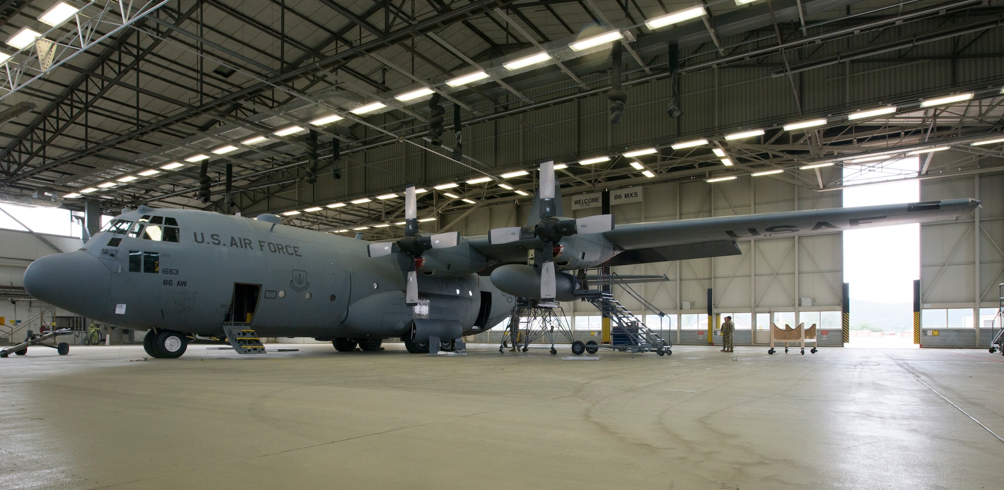 A photo of an aircraft resting in a hangar.