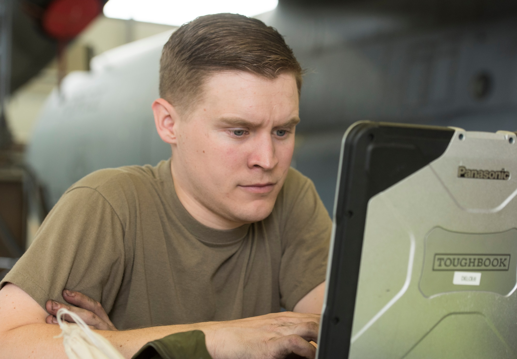 A photo of an Airman reading a technical order.