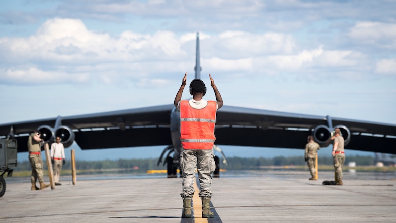 Senior Airman Jar'quayla Doss, 96th Aircraft Maintenance Unit electronic countermeasures journeyman, marshalls a B-52H Stratofortress deployed from Barksdale Air Force Base, La., at Eielson Air Force Base, Alaska,  June 17, 2020. Bomber Task Force missions provide a persistent bomber presence in the Indo-Pacific theater and around the globe. (U.S. Air Force photo by Senior Airman Lillian Miller)
