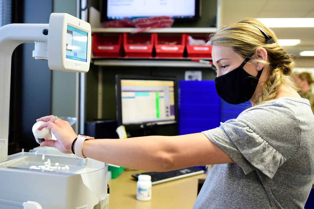 Ashley Tinsley, 92nd Medical Support Squadron certified pharmacy technician, pours medication into a medication counting machine, May 29, 2020, at Fairchild Air Force Base, Wash. Multiple precautions are taken to ensure patients receive the correct amount of medication in the safest way possible, with pharmacy technicians keeping an accurate medication count during and after each step of their processes. (U.S. Air Force photo by Staff Sgt. Nick J. Daniello)