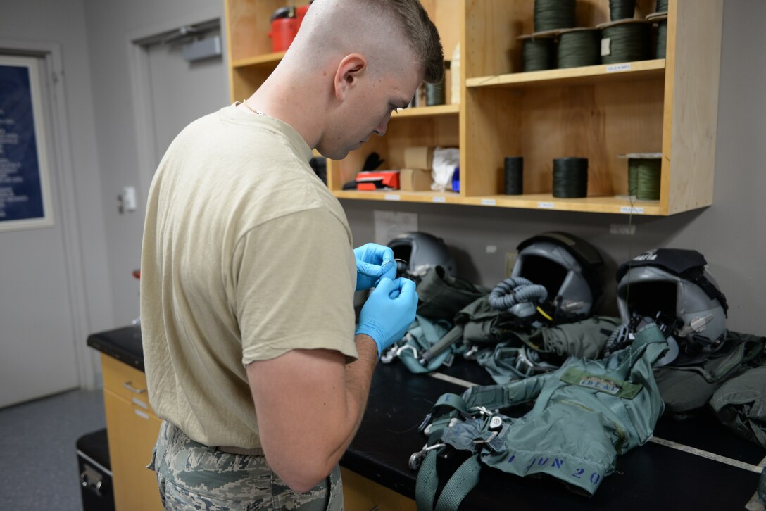 Airman 1st Class Adam Nichols, 37th Flying Training Squadron Aircrew Flight Equipment specialist, prepares to work on a pilot’s harness on June 10, 2020, at Columbus Air Force Base, Miss. AFE specialists perform operator maintenance and service inspections on flight equipment.  (U.S. Air Force photo by Airman 1st Class Davis Donaldson)