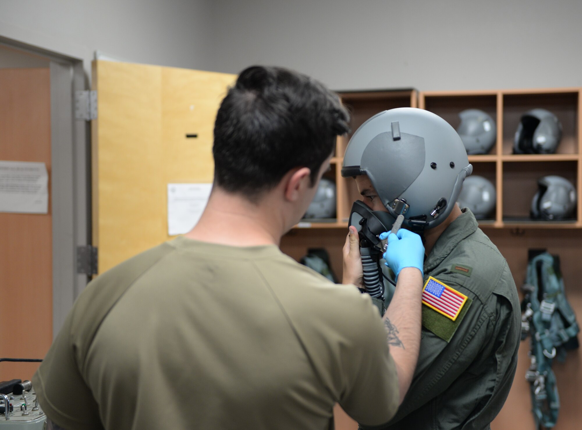 Second Lt. Steven Britt, 37th Flying Training Squadron student pilot, breathes through an oxegen mask, while –Senior Airman Dillon Arizta, 37th FTS Aircrew Flight Equipment specialist, makes sure the mask works properly on June 10, 2020, at Columbus Air Force Base, Miss. AFE specialists are responsible for ensuring that all flight and safety equipment is in perfect working order. (U.S. Air Force photo by Airman 1st Class Davis Donaldson)
