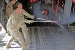 Alaska Air National Guard crew chiefs and pilots assigned to the 176th Wing load a Sikorsky MH-60G Pave Hawk helicopter onto their Boeing C-17 Globemaster III in preparation for deployment to Africa June 3, 2020. The helicopters belong to the ANG's 212th Rescue Squadron assigned to the Wing.