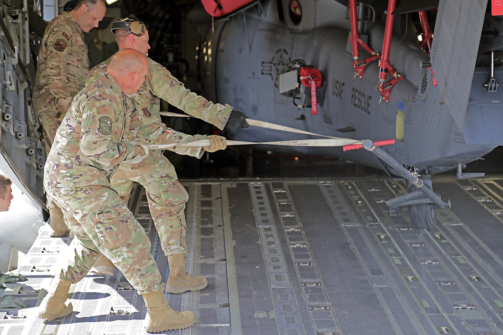 Alaska Air National Guard crew chiefs and pilots assigned to the 176th Wing load a Sikorsky MH-60G Pave Hawk helicopter onto their Boeing C-17 Globemaster III in preparation for deployment to Africa June 3, 2020. The helicopters belong to the ANG's 212th Rescue Squadron assigned to the Wing.