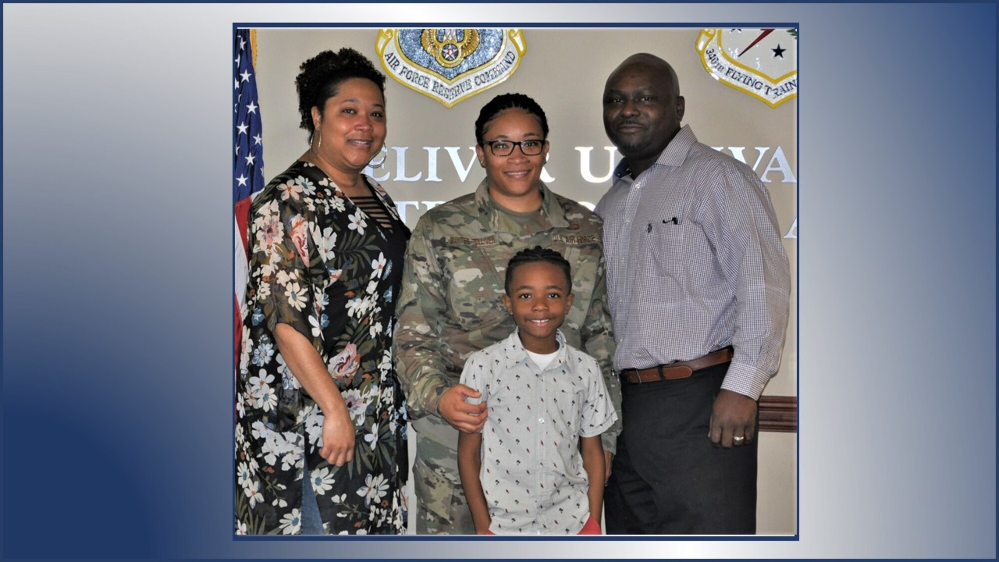 Master Sgt. Andrell Baxter-Tolliver stops for a photo with her family after her promotion ceremony. (U.S. Air Force graphic).