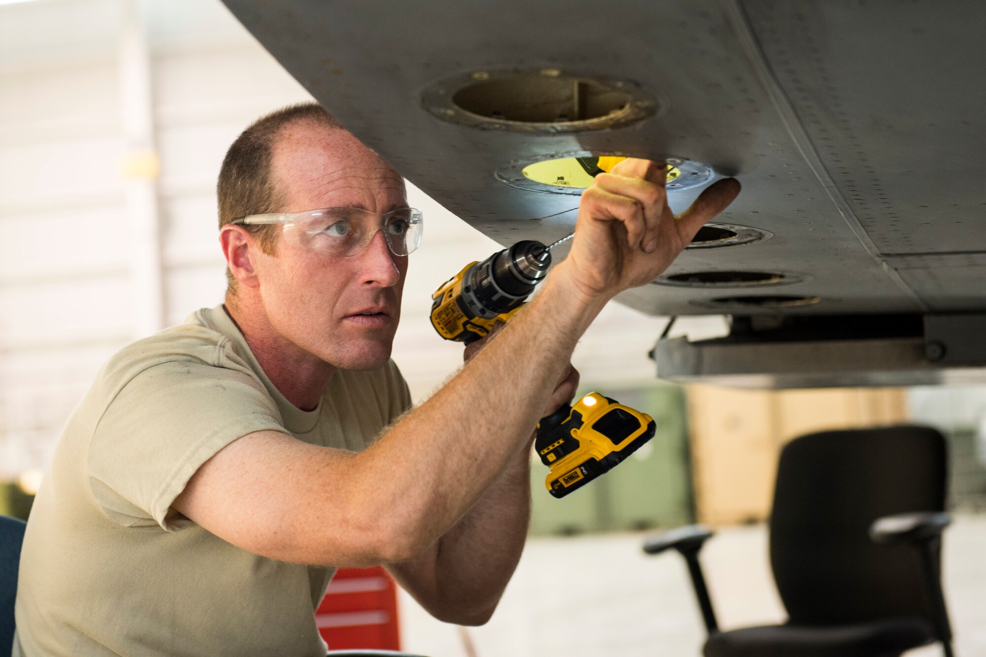 Staff Sgt. Doug Miller, an aircraft maintainer for the 167th Maintenance Group, clears corroded drainage channels inside a C-17 Globemaster III aircraft's cargo ramp canted bulkhead which had corroded over time due to sealed drainage holes, May27, 2020,at the 167th Airlift Wing, Martinsburg, W.Va.