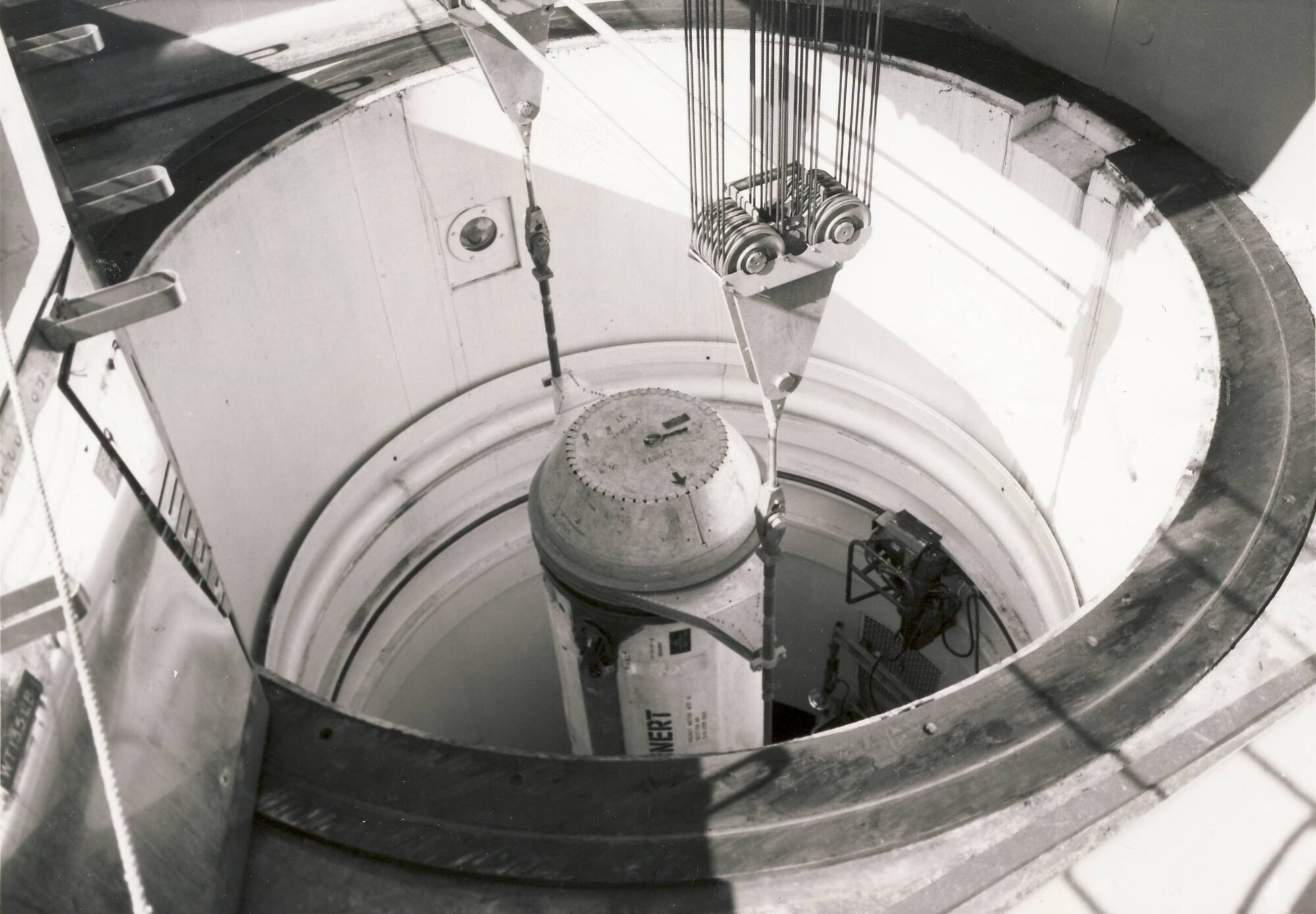 Originally constructed in 1965, the Hill Engineering and Test Facility allowed the Ogden Air Logistics Center (ALC) to complete system-level testing and integration during the 1980s. This photograph depicts an inert Minuteman ICBM being lowered into its silo at the facility during construction.