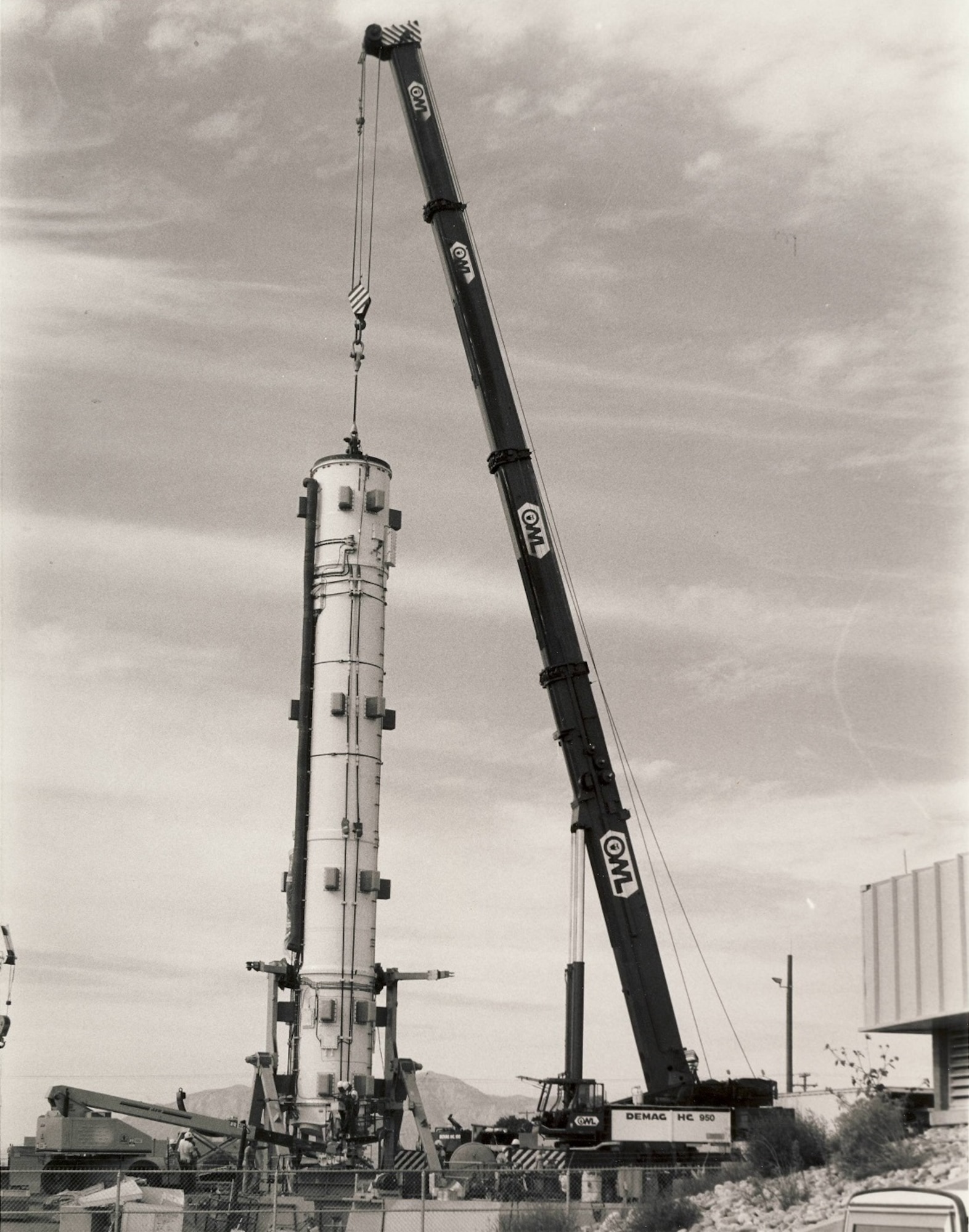 The Hill Engineering and Test Facility received several upgrades and additions during the 1960s, 70s, and 80s. During 1989, the Peacekeeper ICBM portion of the facility became operational. This photograph depicts the installation of an inert Peacekeeper ICBM as it was lowered into its silo at the facility.