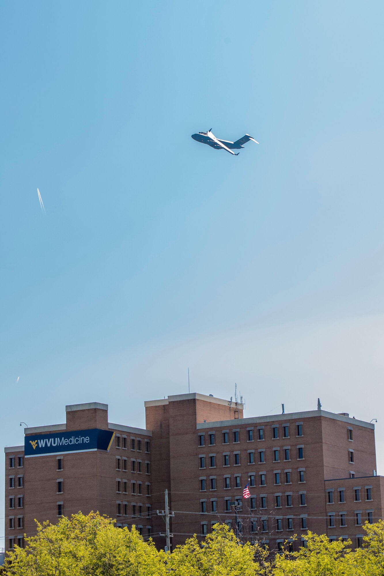 A 167th Airlift Wing C-17 Globemaster III aircraft flies over Berkeley Medical Center in Martinsburg, W.Va., May 13, 2020,as part of Operation American Resolve, a nation-wide salute to those supporting the COVID-19 response efforts.