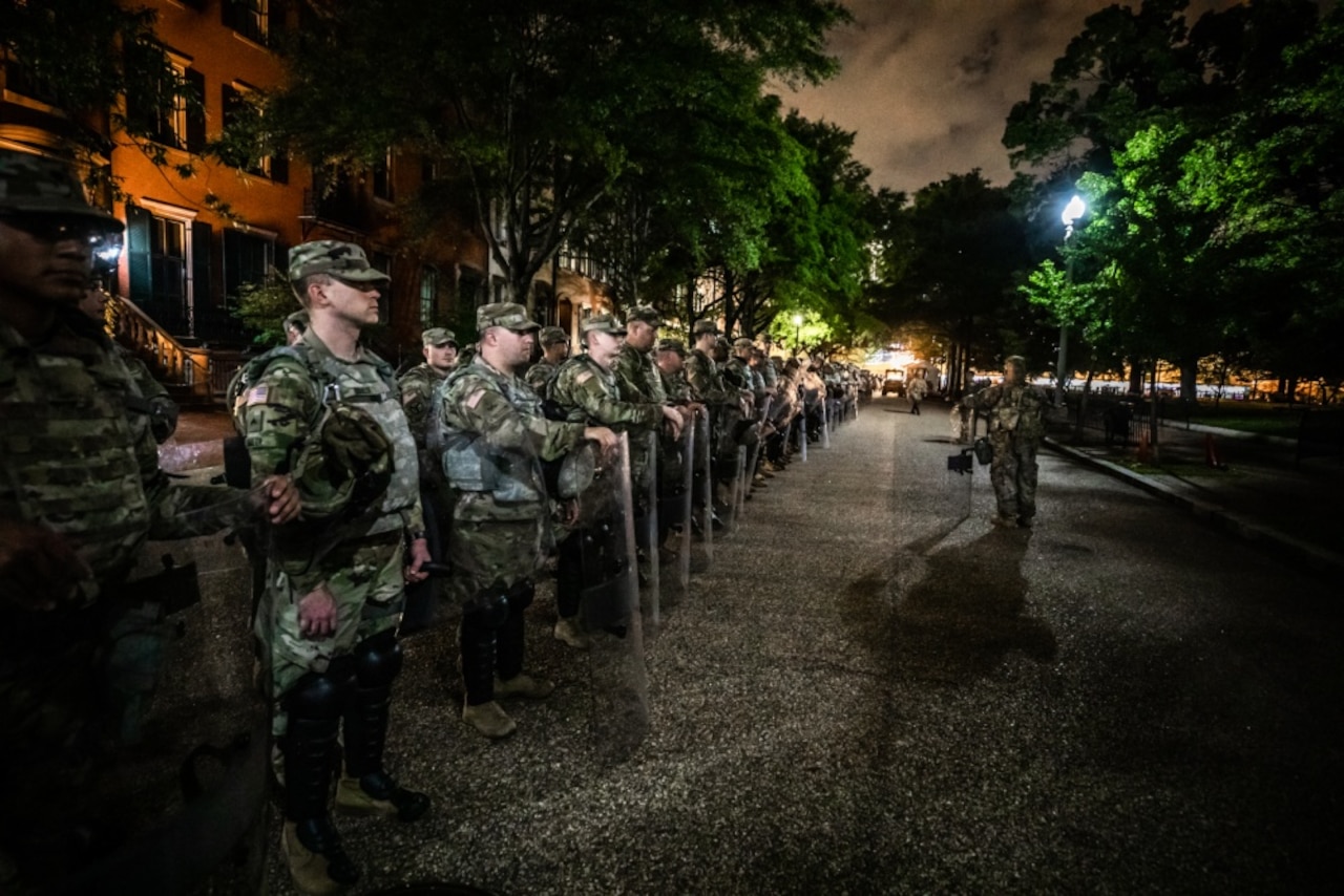 National guardsmen stand ready to support local police in quelling riots in Washington, D.C.