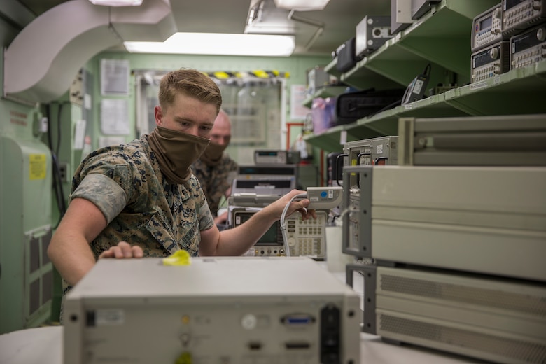 U.S. Marines with Marine Aviation Logistics Squadron (MALS) 13, calibrate aircraft electronics on Marine Corps Air Station (MCAS) Yuma, May 27, 2020. The calibration work center is responsible for maintaining mission readiness across all MCAS Yuma tenant squadrons and 6,000 items through calibration and equipment repair for aircraft electronics, armory gauges, and weapon test sets. (U.S. Marine Corps photo by Lance Cpl John Hall)